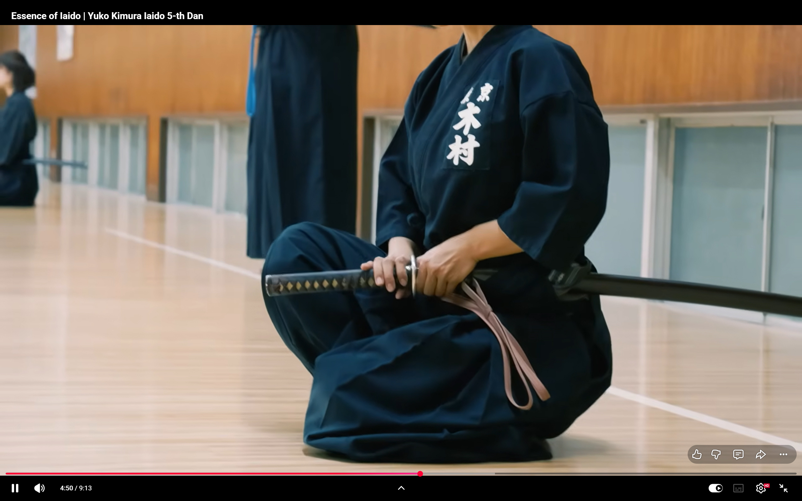 Iaido student seated with sword